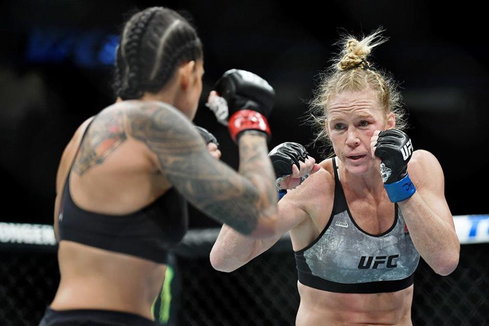 Jul 6, 2019; Las Vegas, NV, USA; Amanda Nunes (red gloves) fights against Holly Holm (blue gloves) at T-Mobile Arena. Mandatory Credit: Stephen R. Sylvanie-USA TODAY Sports