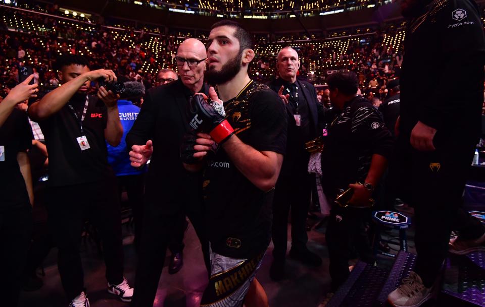 Jan 18, 2025; Inglewood, California, USA; Islam Makhachev (red gloves) leaves the octagon after defeating Renato Moicano (not pictured) in a lightweight title fight during UFC 311 at Intuit Dome. Mandatory Credit: Gary A. Vasquez-Imagn Images