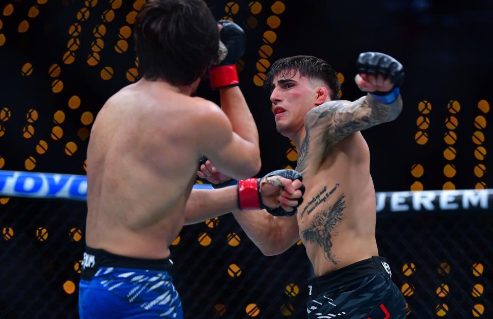 Jan 18, 2025; Inglewood, California, USA; Ricky Turcios (red gloves) fights Benardo Sopaj (blue gloves) during UFC 311 at Intuit Dome. Mandatory Credit: Gary A. Vasquez-Imagn Images