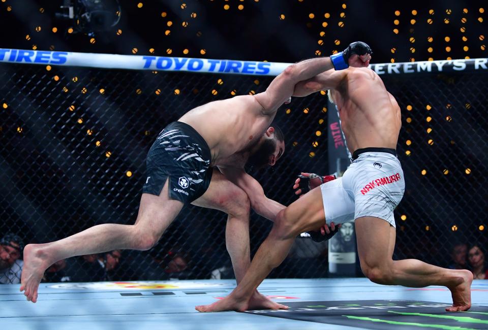 Jan 18, 2025; Inglewood, California, USA; Rinya Nakamura (red gloves) fights Muin Gafurov (blue gloves) during UFC 311 at Intuit Dome. Mandatory Credit: Gary A. Vasquez-Imagn Images