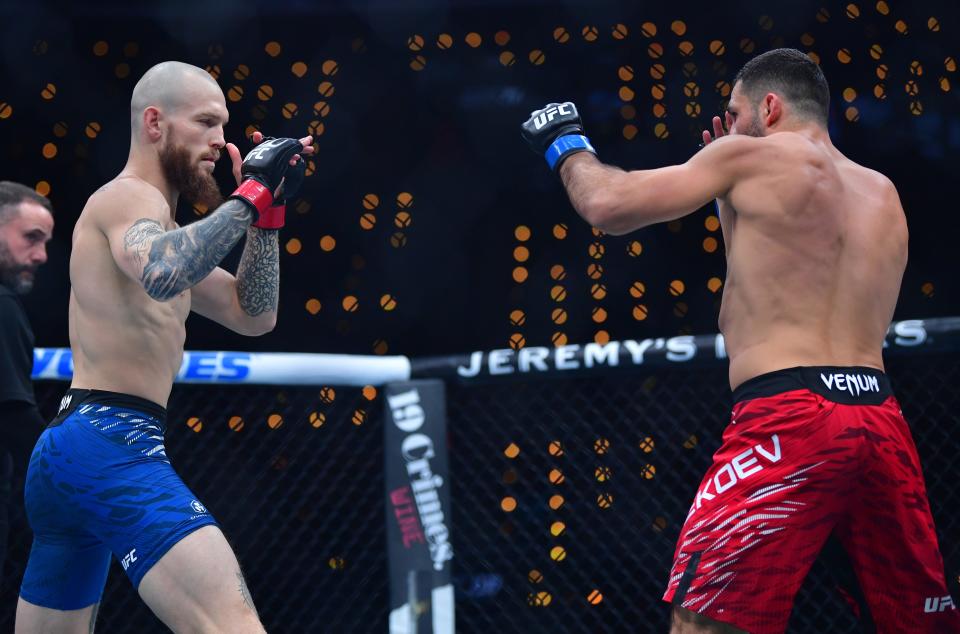 Jan 18, 2025; Inglewood, California, USA; Zachary Reese (red gloves) fights Azamat Bekoev (blue gloves) during UFC 311 at Intuit Dome. Mandatory Credit: Gary A. Vasquez-Imagn Images