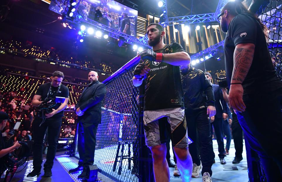 Jan 18, 2025; Inglewood, California, USA; Islam Makhachev (red gloves) leaves the octagon after defeating Renato Moicano (not pictured) in a lightweight title fight during UFC 311 at Intuit Dome. Mandatory Credit: Gary A. Vasquez-Imagn Images