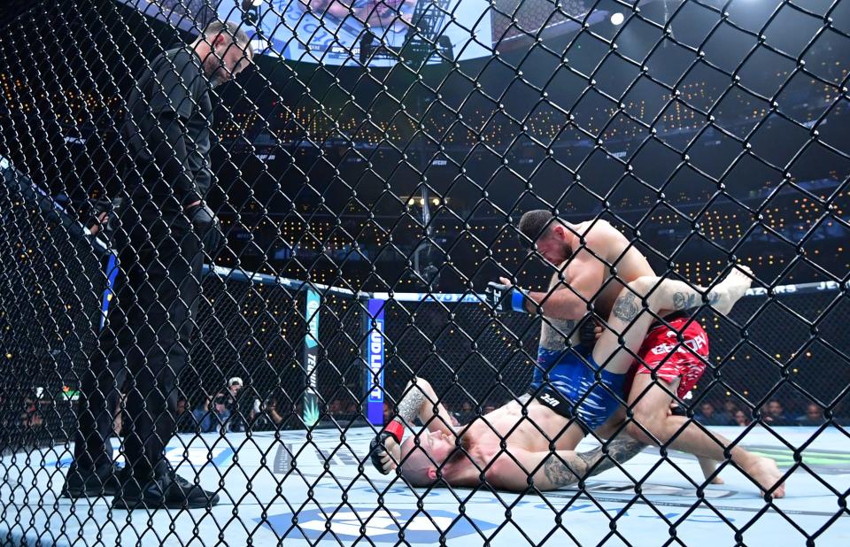 Jan 18, 2025; Inglewood, California, USA; Zachary Reese (red gloves) fights Azamat Bekoev (blue gloves) during UFC 311 at Intuit Dome. Mandatory Credit: Gary A. Vasquez-Imagn Images