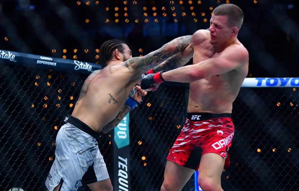 Jan 18, 2025; Inglewood, California, USA; Grant Dawson (red gloves) fights Diego Ferreira (blue gloves) during UFC 311 at Intuit Dome. Mandatory Credit: Gary A. Vasquez-Imagn Images