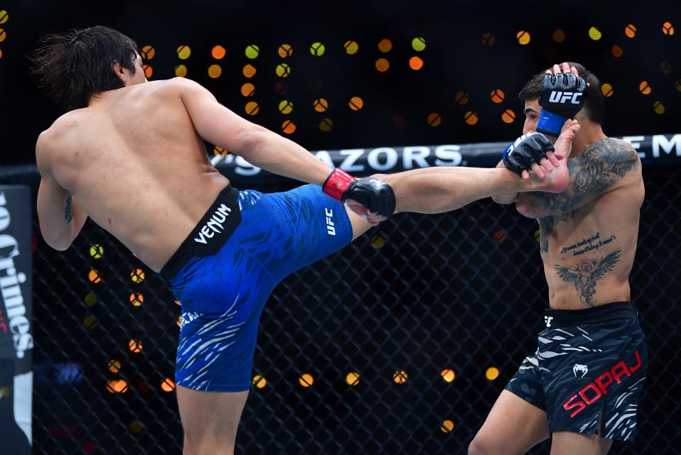 Jan 18, 2025; Inglewood, California, USA; Ricky Turcios (red gloves) fights Benardo Sopaj (blue gloves) during UFC 311 at Intuit Dome. Mandatory Credit: Gary A. Vasquez-Imagn Images