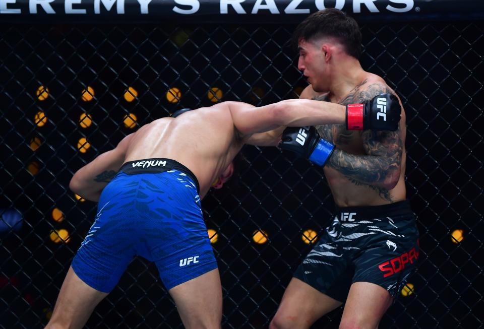 Jan 18, 2025; Inglewood, California, USA; Ricky Turcios (red gloves) fights Benardo Sopaj (blue gloves) during UFC 311 at Intuit Dome. Mandatory Credit: Gary A. Vasquez-Imagn Images