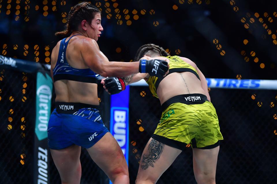 Jan 18, 2025; Inglewood, California, USA; Karol Rosa (red gloves) fights Ailin Perez (blue gloves) during UFC 311 at Intuit Dome. Mandatory Credit: Gary A. Vasquez-Imagn Images