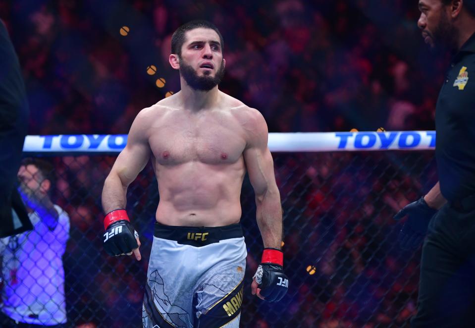 Jan 18, 2025; Inglewood, California, USA; Islam Makhachev (red gloves) reacts after defeating Renato Moicano (blue gloves) in a lightweight title fight during UFC 311 at Intuit Dome. Mandatory Credit: Gary A. Vasquez-Imagn Images