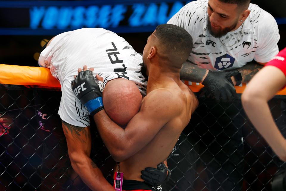 Nov 2, 2024; Edmonton, Alberta, Canada; Youssef Zalal (blue gloves) celebrates after defeating Jack Shore (red gloves) in a featherweight bout during UFC Fight Night at Rogers Place. Mandatory Credit: Perry Nelson-Imagn Images