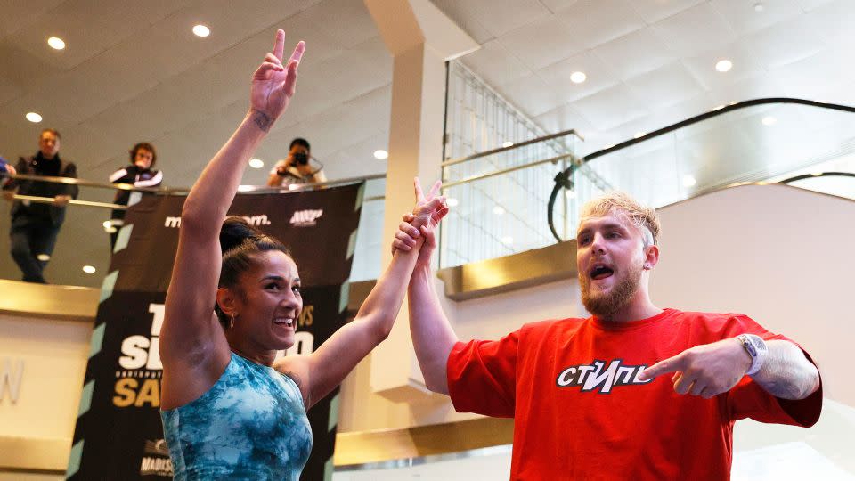 Paul introduces Amanda Serrano during a public workout, held days before her world lightweight title fight in April 2022. - Sarah Stier/Getty Images/File