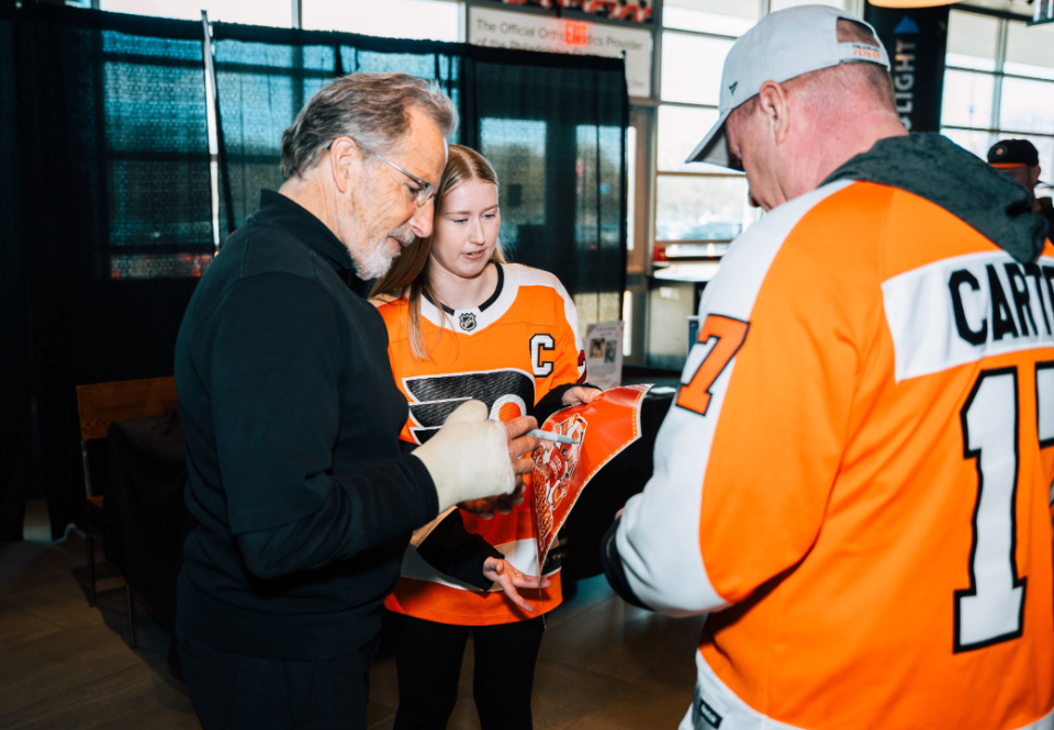 Philadelphia Flyers head coach John Tortorella signs an autograph for a fan. (Credit: Philadelphia Flyers)