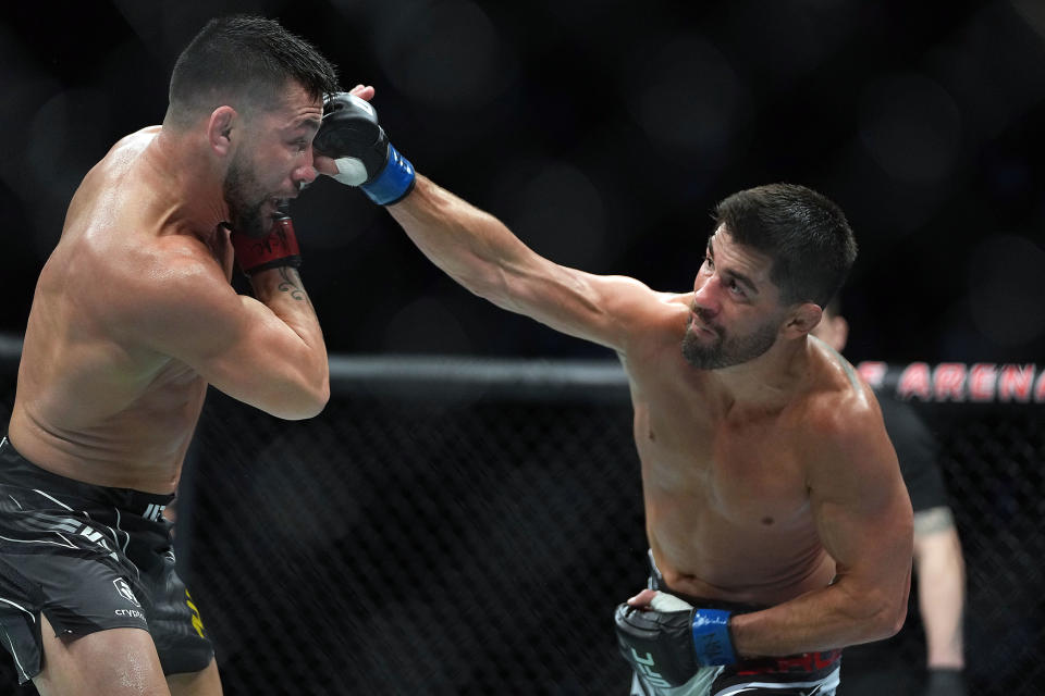 Dec 11, 2021; Las Vegas, Nevada, USA; Dominick Cruz lands a kick against Pedro Munhoz during UFC 269 at T-Mobile Arena. Mandatory Credit: Stephen R. Sylvanie-USA TODAY Sports