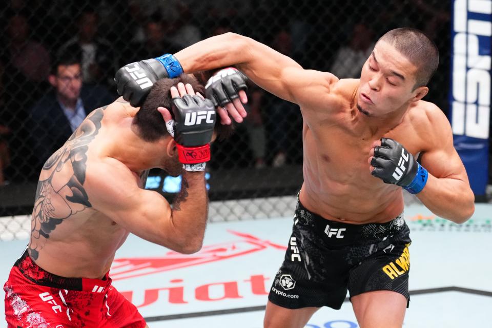 LAS VEGAS, NEVADA - OCTOBER 19: (R-L) Asu Almabayev of Kazakstan punches Matheus Nicolau of Brazil in a flyweight fight during the UFC Fight Night event at UFC APEX on October 19, 2024 in Las Vegas, Nevada. (Photo by Jeff Bottari/Zuffa LLC)