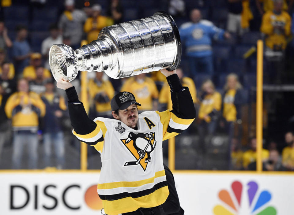 Jun 11, 2017; Nashville, TN, USA; Pittsburgh Penguins center Evgeni Malkin (71) hoists the Stanley Cup after defeating the Nashville Predators in game six of the 2017 Stanley Cup Final at Bridgestone Arena. Mandatory Credit: Christopher Hanewinckel-Imagn Images