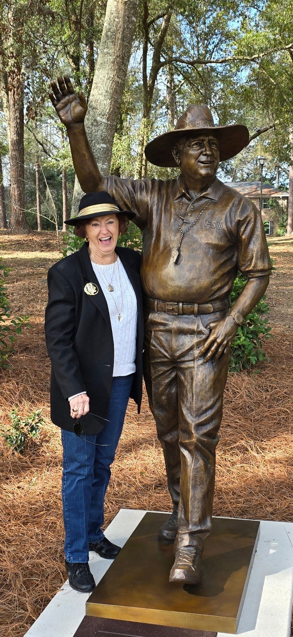 Sue Hall poses near the Bobby Bowden statue at The Killearn Club. Hall was Bowden's longtime administrative assistant at Florida State.