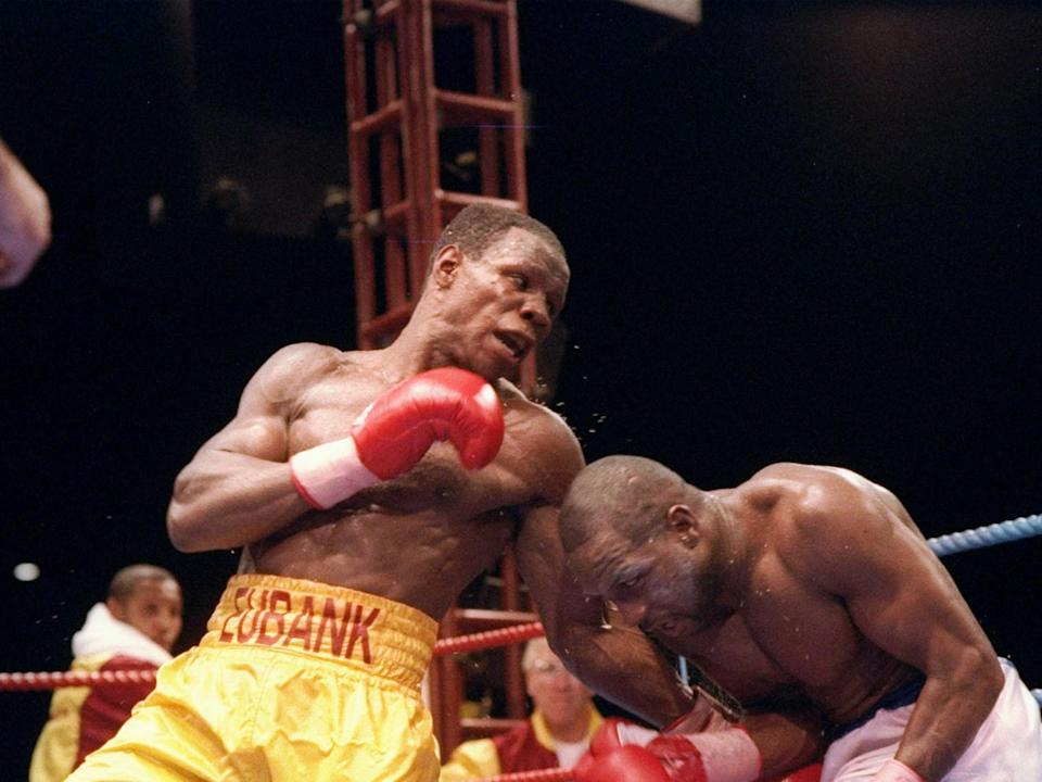 Chris Eubank Sr (left) trades blows with Nigel Benn in 1993 (Getty)