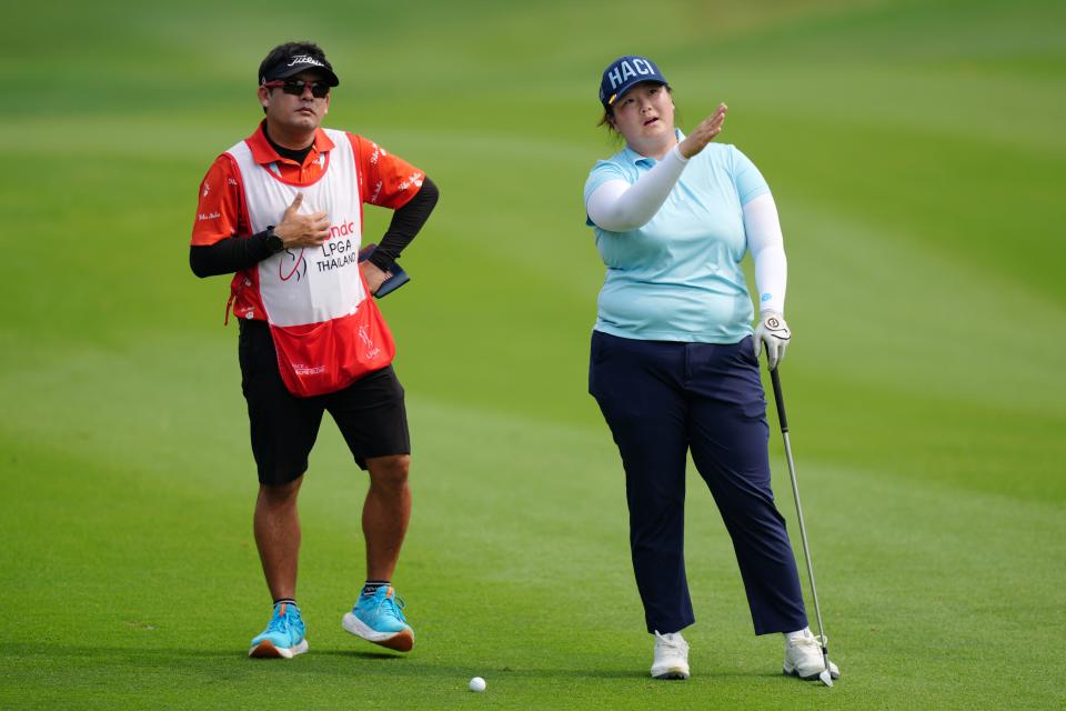 Angel Yin of the United States discusses with her caddie Sakchai Sirimaya before her second shot on the 3rd hole during the final round of the Honda LPGA Thailand 2025 at Siam Country Club on February 23, 2025 in Chon Buri, Thailand.