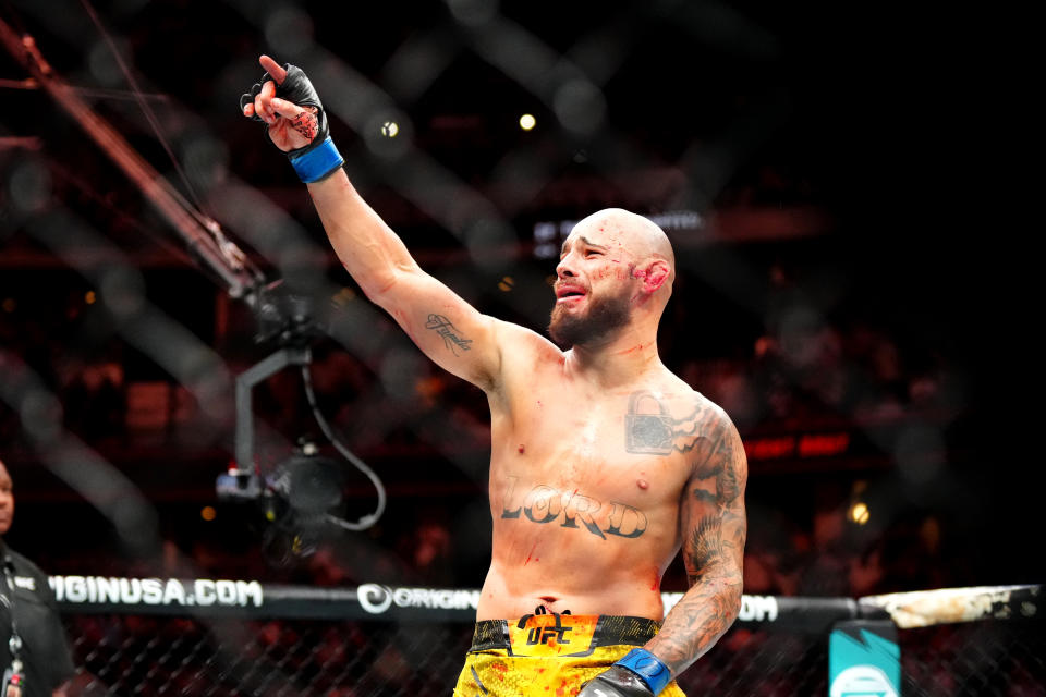 Jul 13, 2024; Denver, Colorado, USA; Jean Silva (blue gloves) celebrates defeating Drew Dober (red gloves) during UFC Fight Night at Ball Arena. Mandatory Credit: Ron Chenoy-USA TODAY Sports