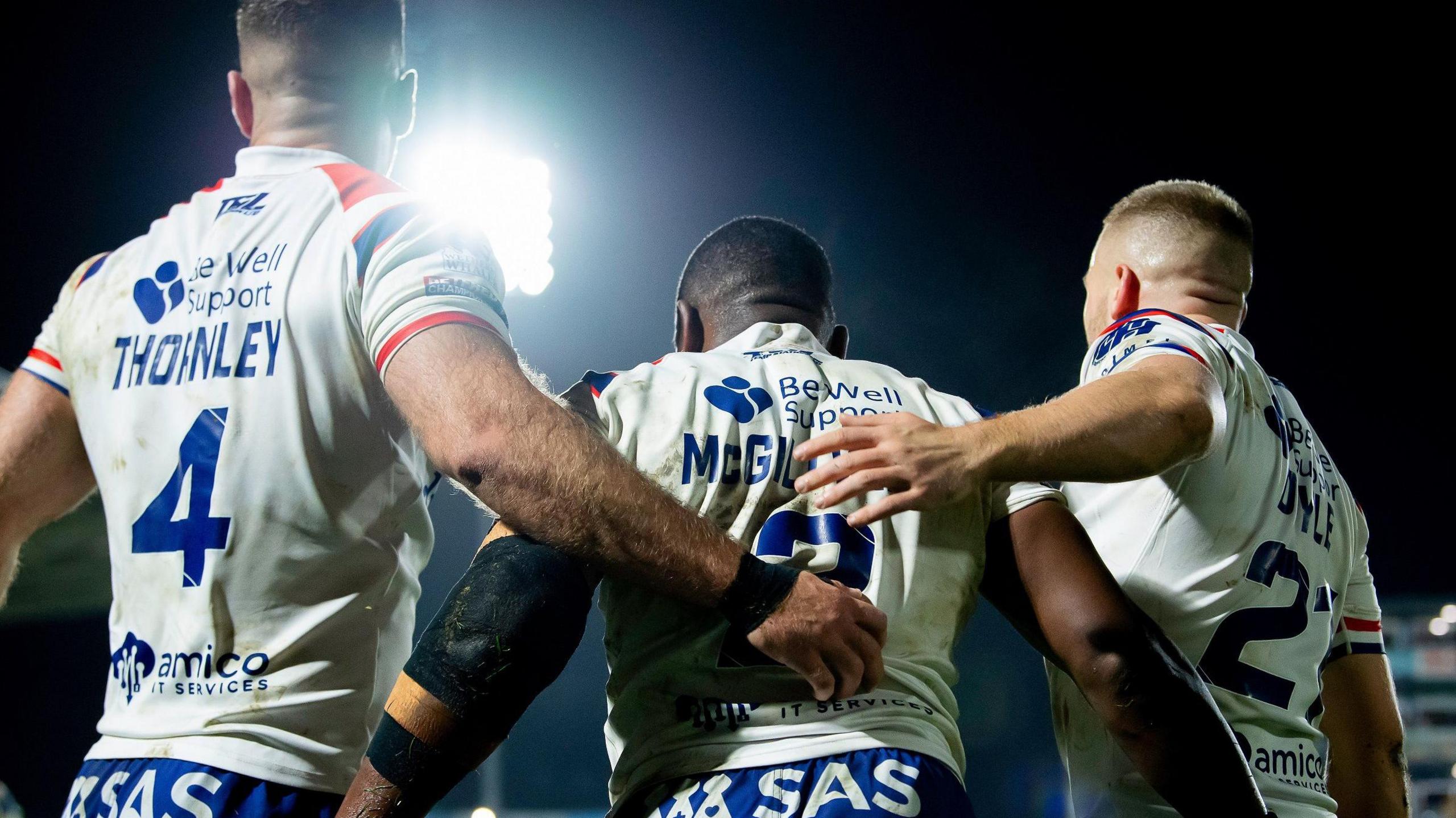 Jermaine McGillvary is embraced by Tommy Doyle and Iain Thornley after scoring a try for Wakefield