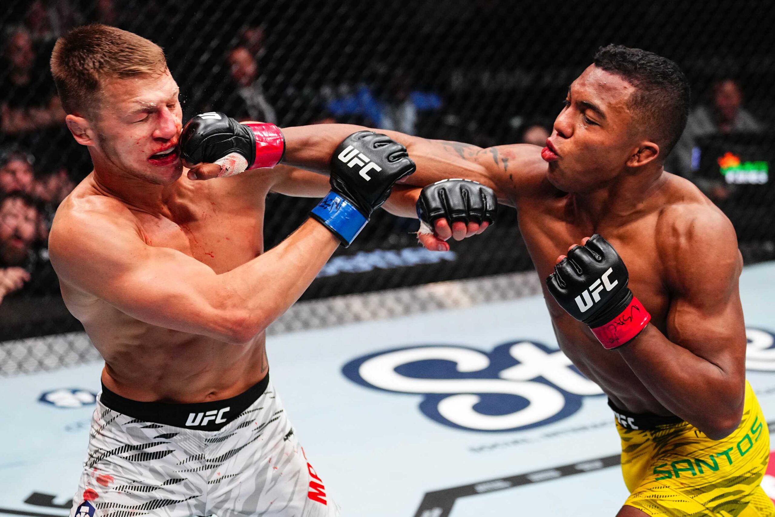 LAS VEGAS, NEVADA - MARCH 08: (R-L) Mairon Santos of Brazil punches Francis Marshall in a featherweight fight during the UFC 313 event at T-Mobile Arena on March 08, 2025 in Las Vegas, Nevada.  (Photo by Jeff Bottari/Zuffa LLC)