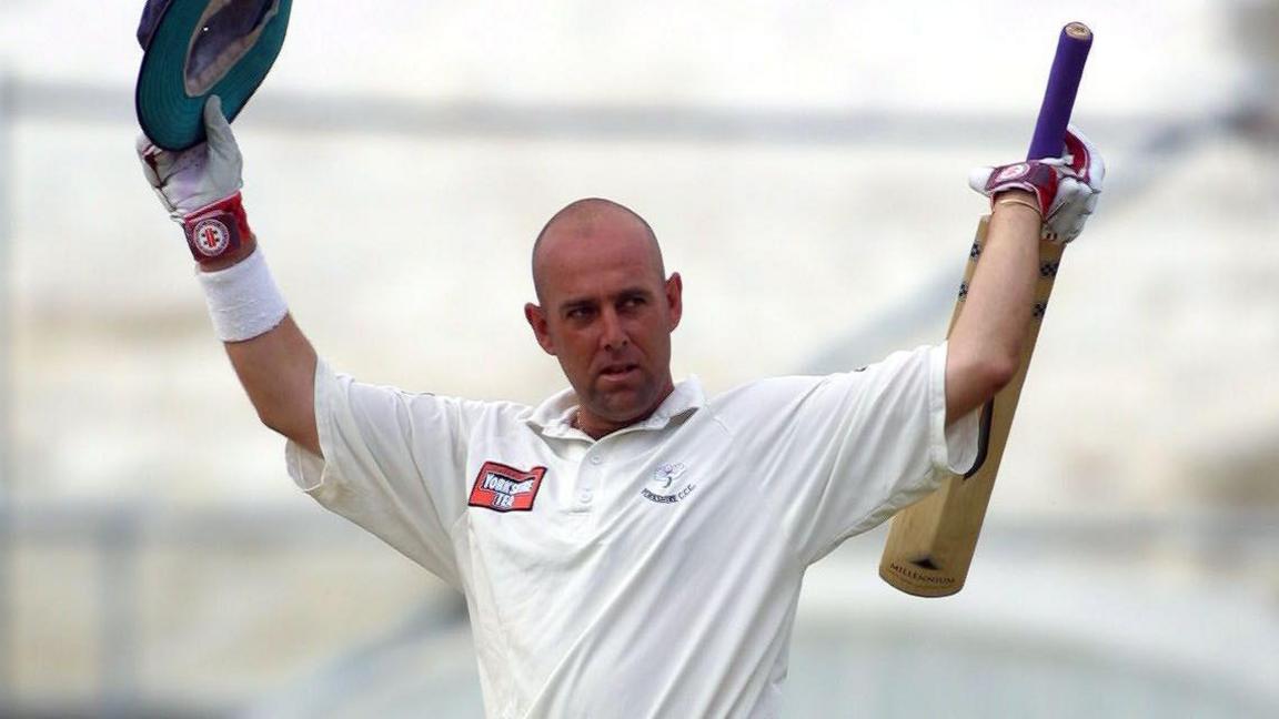 Darren Lehmann raises his hat and bat after scoring a hundred for Yorkshire during the 2001 County Championship