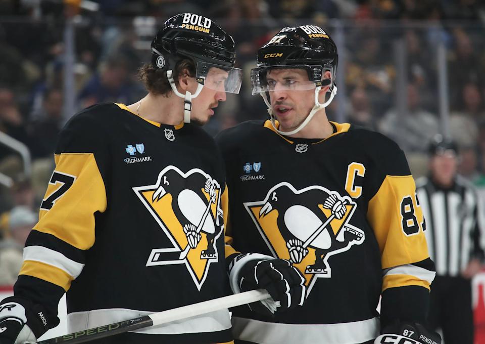 Mar 2, 2025; Pittsburgh, Pennsylvania, USA; Pittsburgh Penguins right wing Rickard Rakell (67) and center Sidney Crosby (87) talk before a face-off against the Toronto Maple Leafs during the first period at PPG Paints Arena. (Charles LeClaire-Imagn Images)