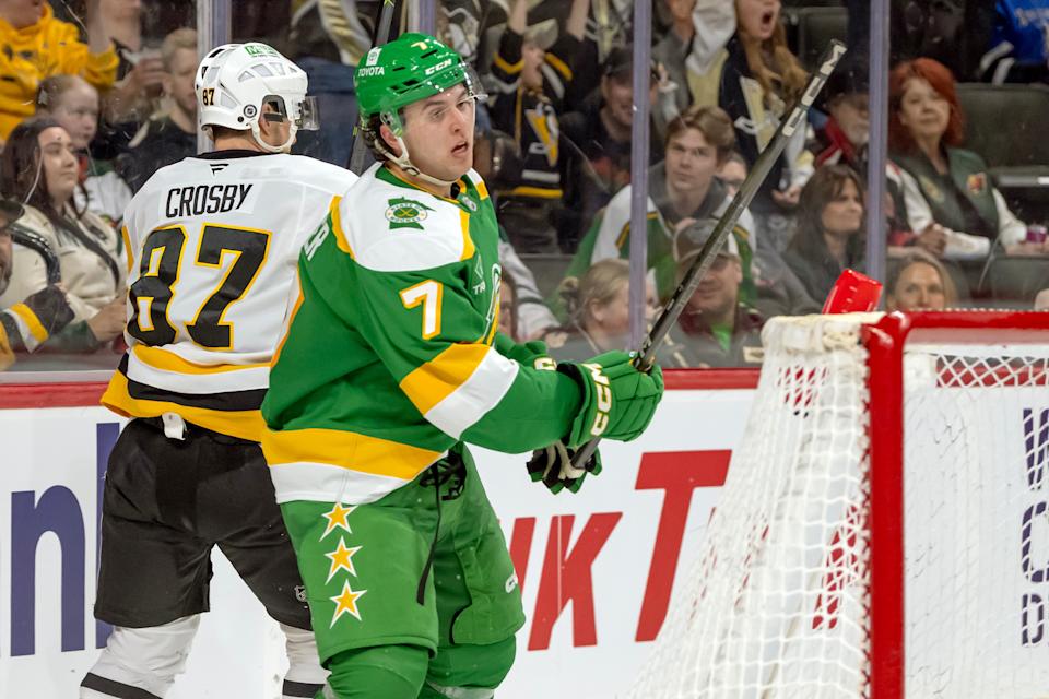 Mar 9, 2025; Saint Paul, Minnesota, USA; Minnesota Wild defenseman Brock Faber (7) breaks his stick over the net after an empty net goal by Pittsburgh Penguins forward Sidney Crosby (87) during the third period at Xcel Energy Center. Mandatory Credit: Nick Wosika-Imagn Images.