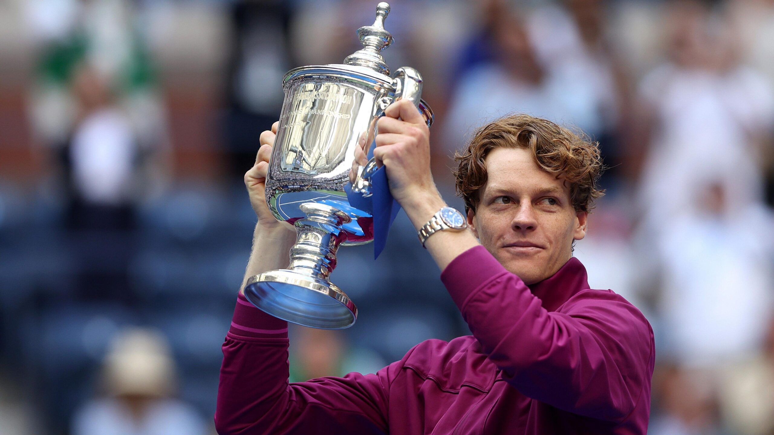 Jannik Sinner holds the US Open trophy aloft after his victory in 2024