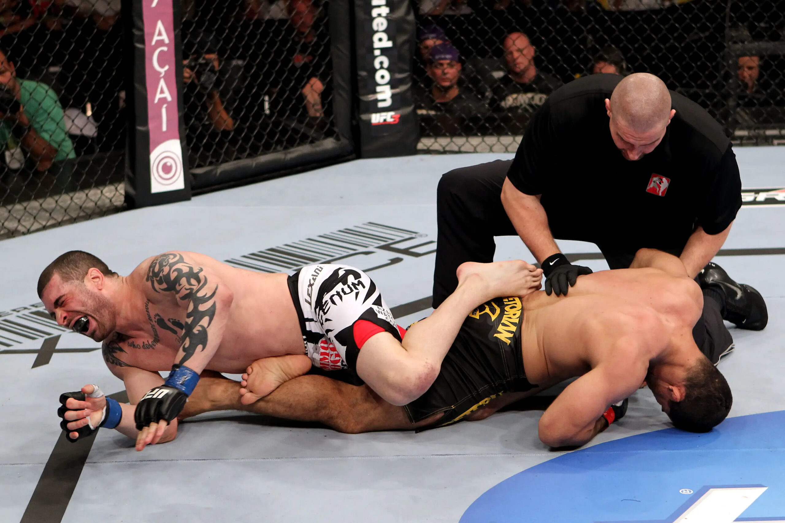 RIO DE JANEIRO, BRAZIL - JANUARY 14: Referee Leon Roberts (Top) calls the fight as Rousimar Palhares (R) puts Mike Massenzio (L) into a leg lock in a middleweight bout during UFC 142 at HSBC Arena on January 14, 2012 in Rio de Janeiro, Brazil. (Photo by Josh Hedges/Zuffa LLC/Zuffa LLC via Getty Images)