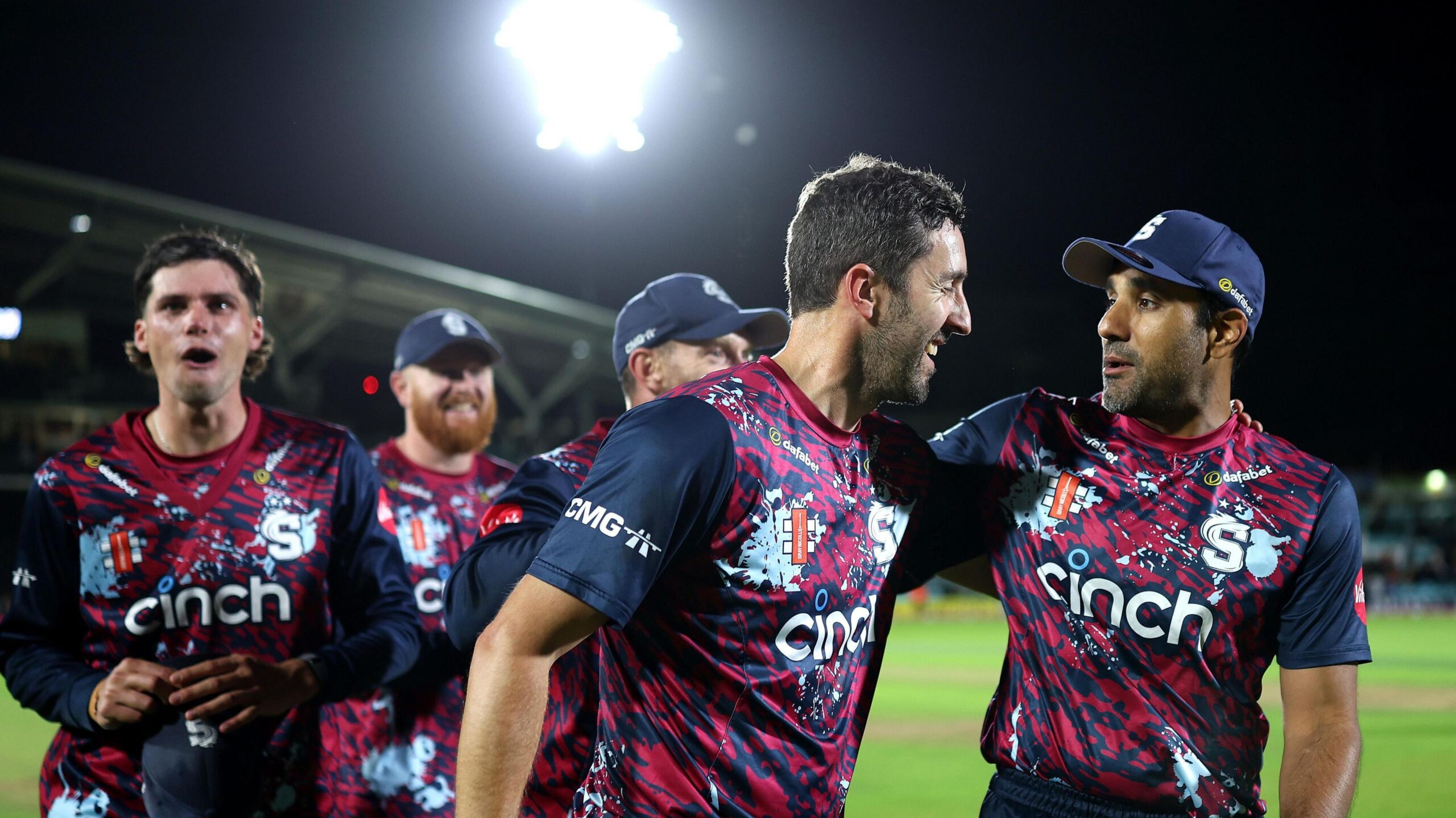 Ben Sanderson (centre) has his left arm around the shoulder of Ravi Bopara as they leave the field at The Kia Oval with three players following behind them