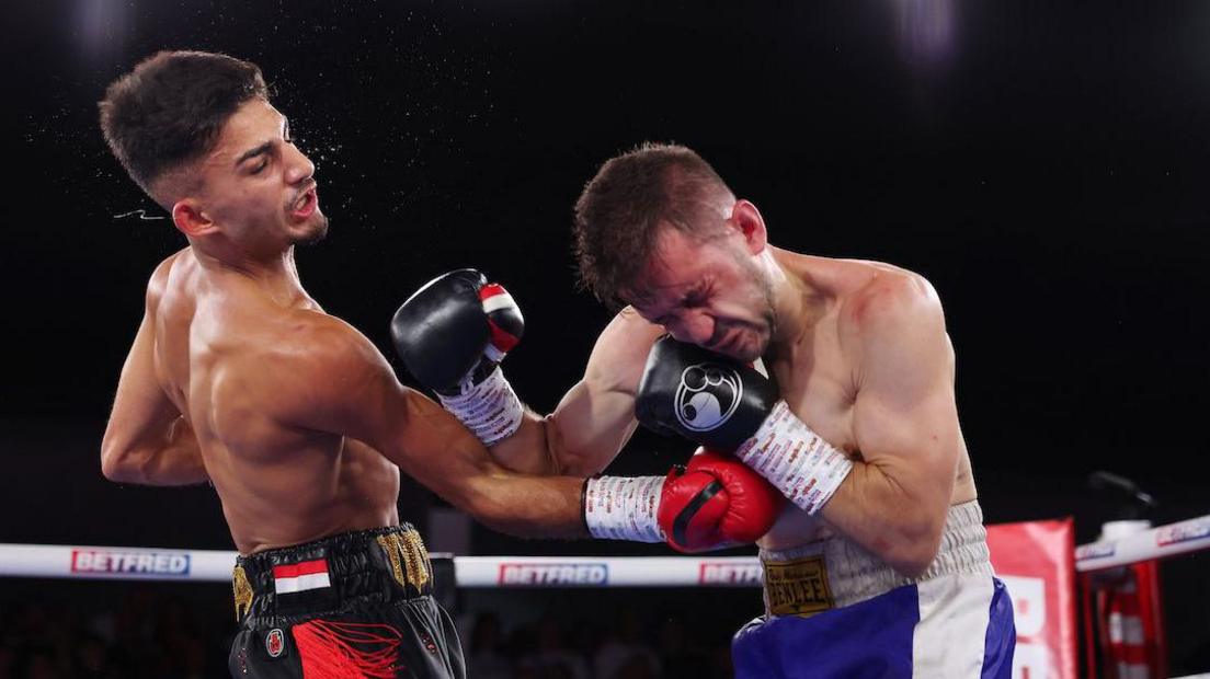 Adam Maca punches Francisco Rodriguez with an uppercut