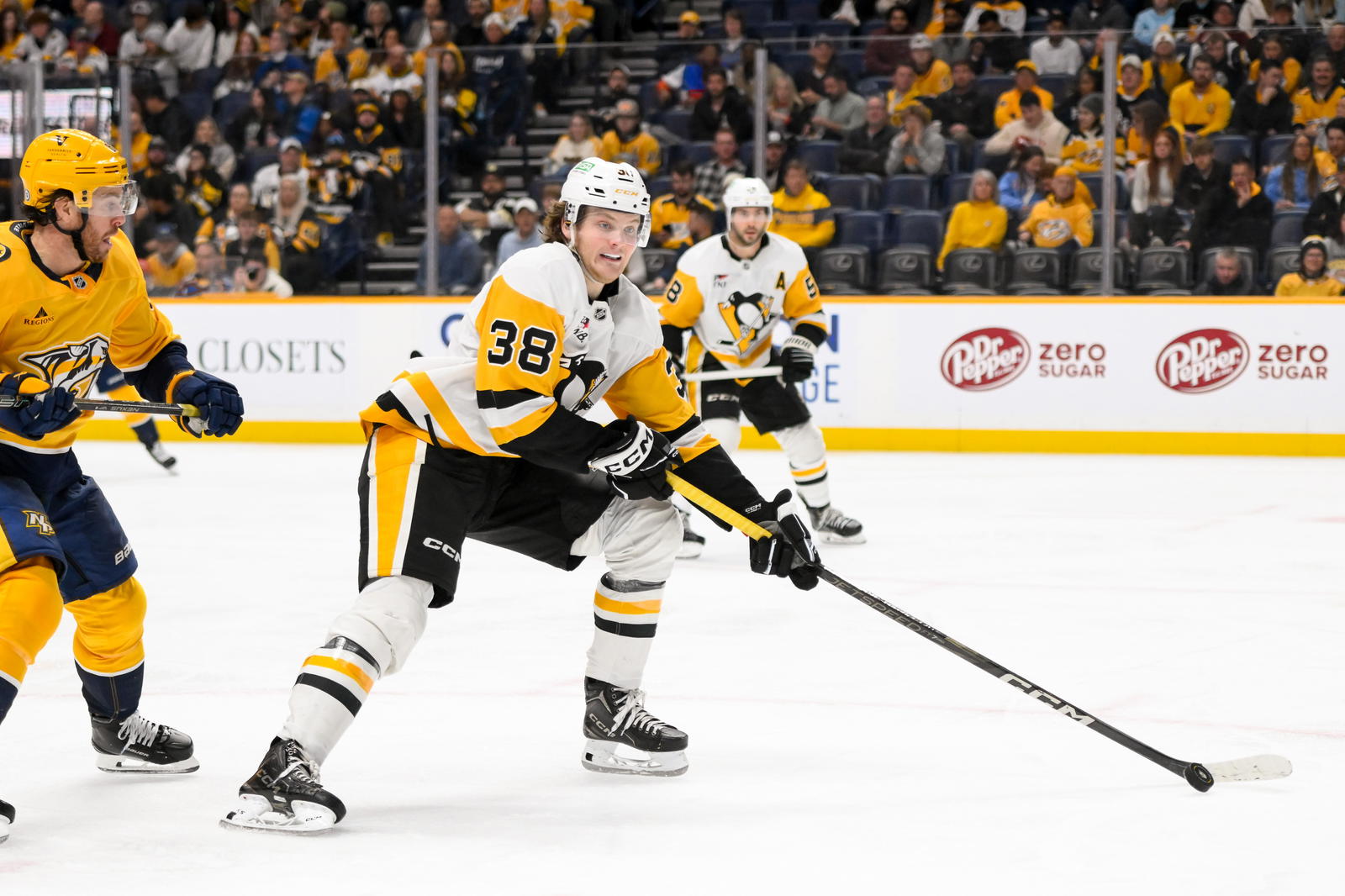Dec 19, 2024; Nashville, Tennessee, USA; Pittsburgh Penguins defenseman Owen Pickering (38) skates with the puck against the Nashville Predators during the third period at Bridgestone Arena. Mandatory Credit: Steve Roberts-Imagn Images