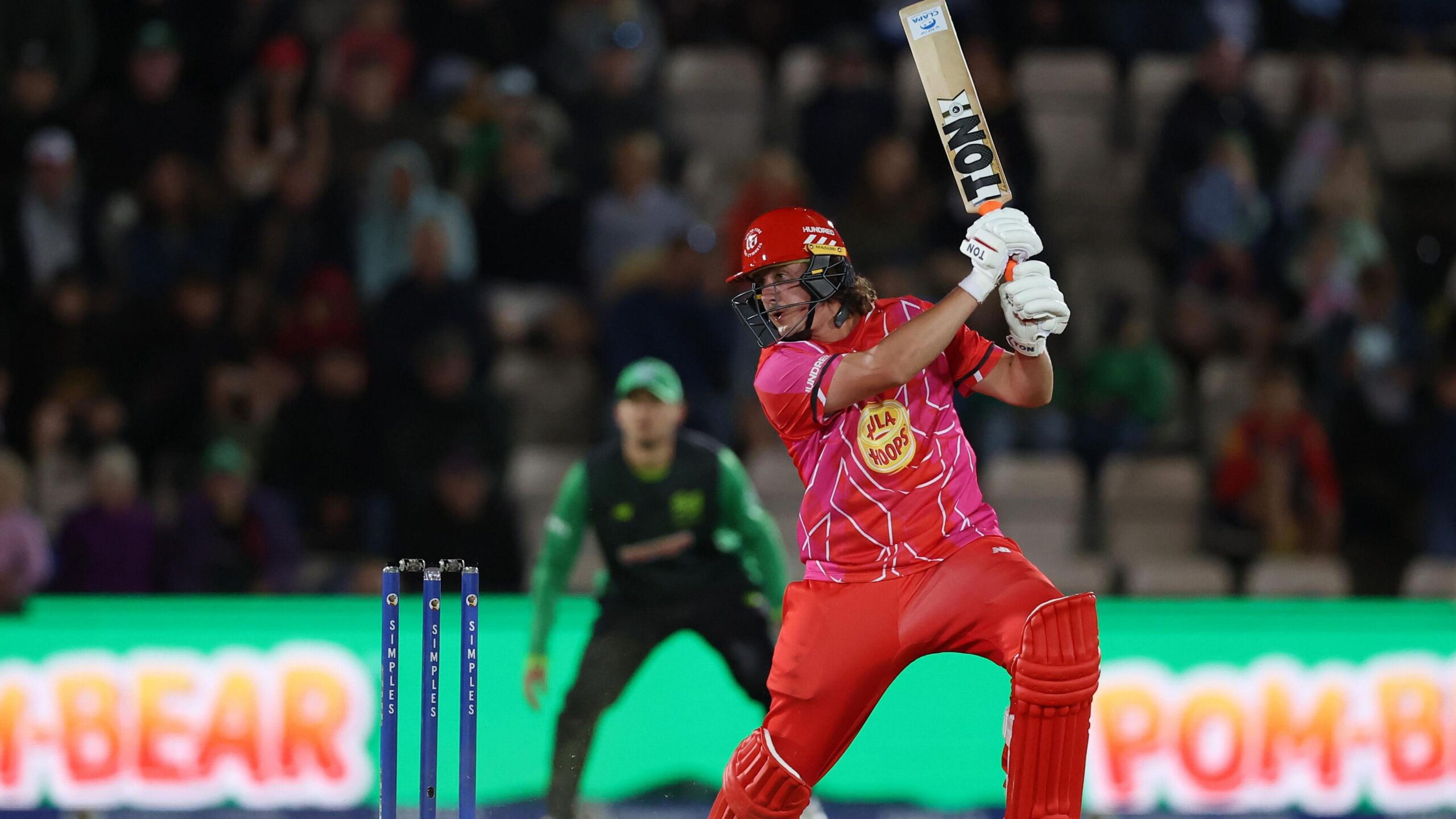 Tom Kohler-Cadmore raising his bat in the air with the CLAPA sticker showing while playing for Welsh Fire