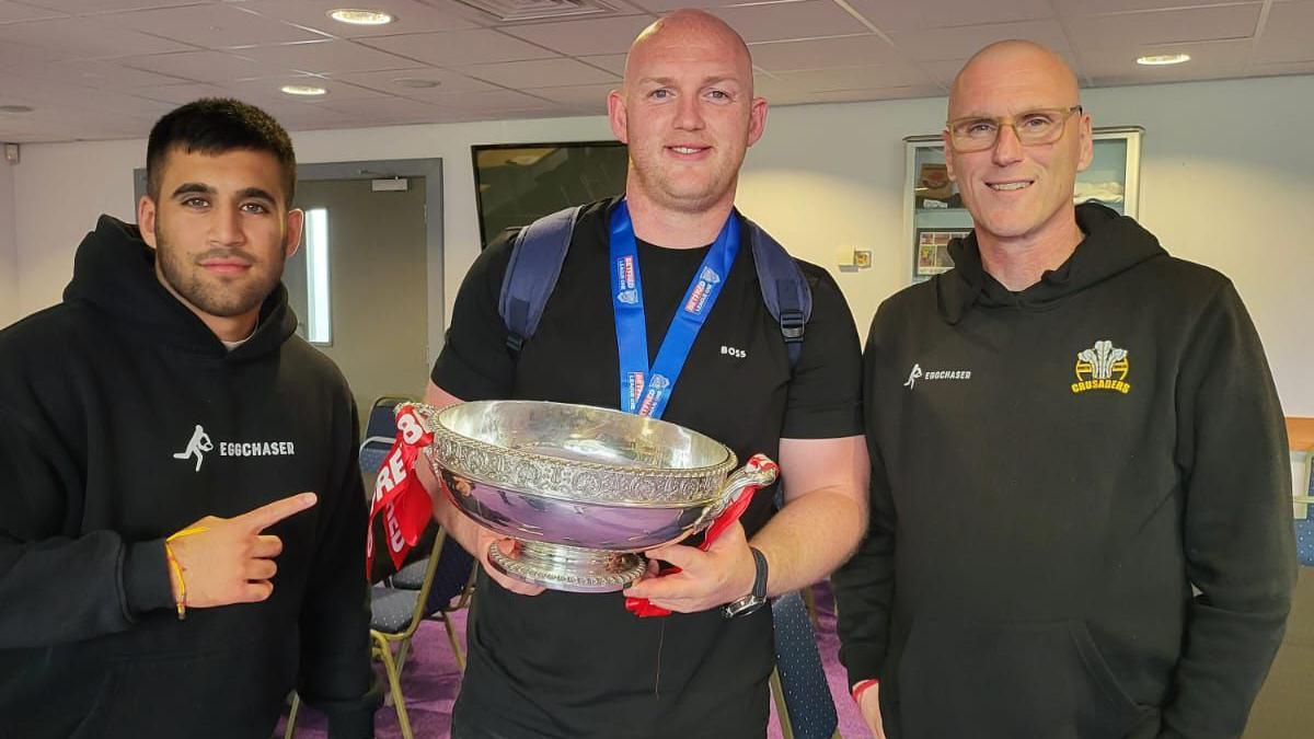 Arun Watkins, Carl Foster and Bobby Watkins celebrate Crusaders' title win