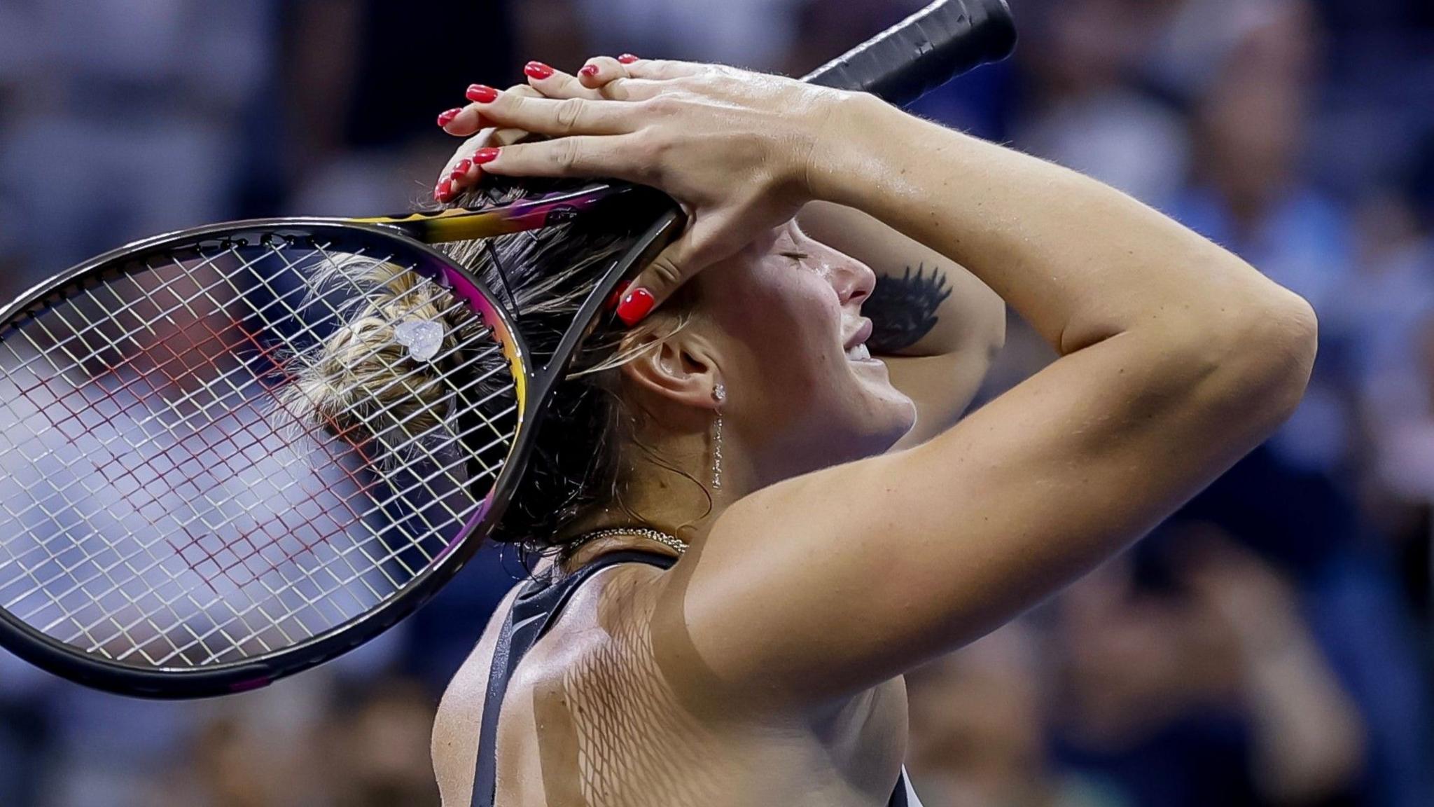 Aryna Sabalenka raises her head in relief after her US Open victory