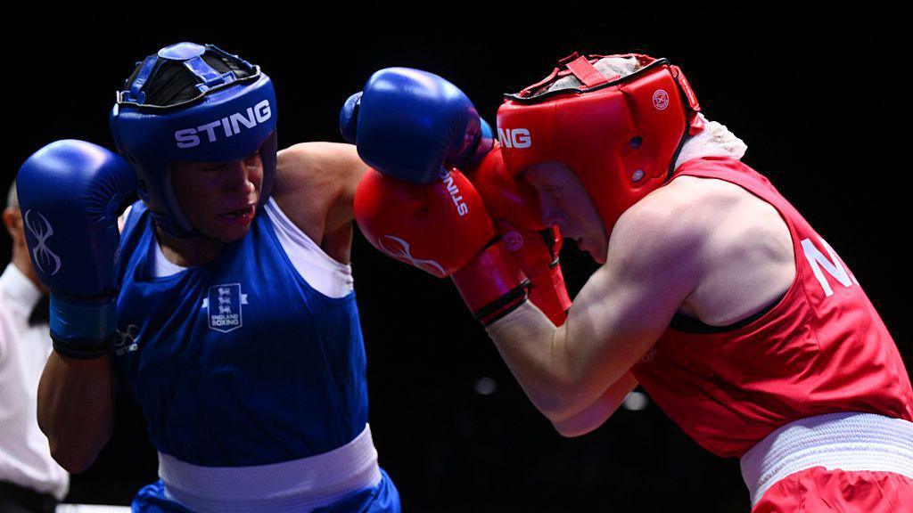 Chantelle Reid of England in blue Morgan Adele Henderson of New Zealand in red