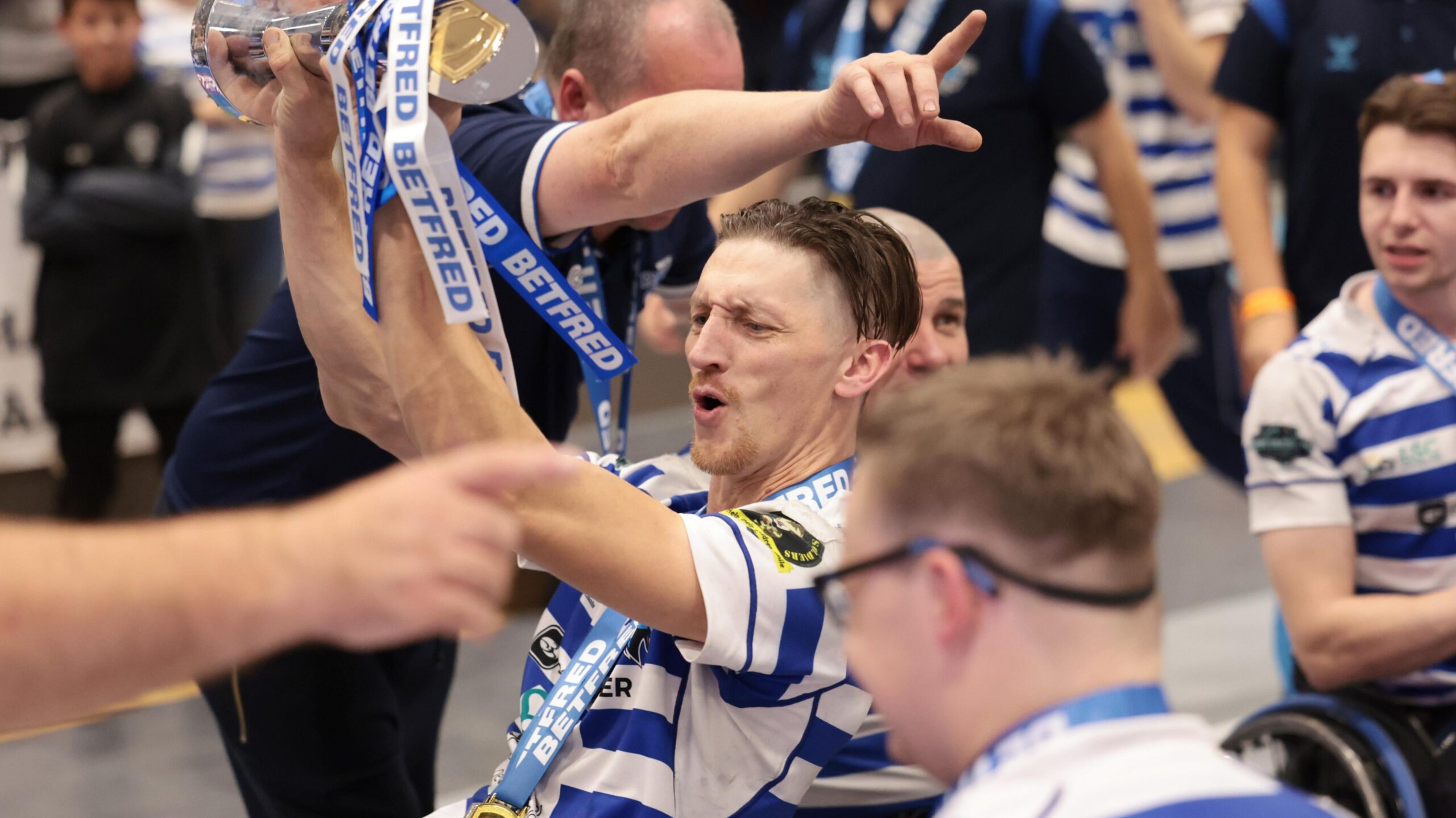 Jack Brown celebrates with a trophy as his team-mates gather round