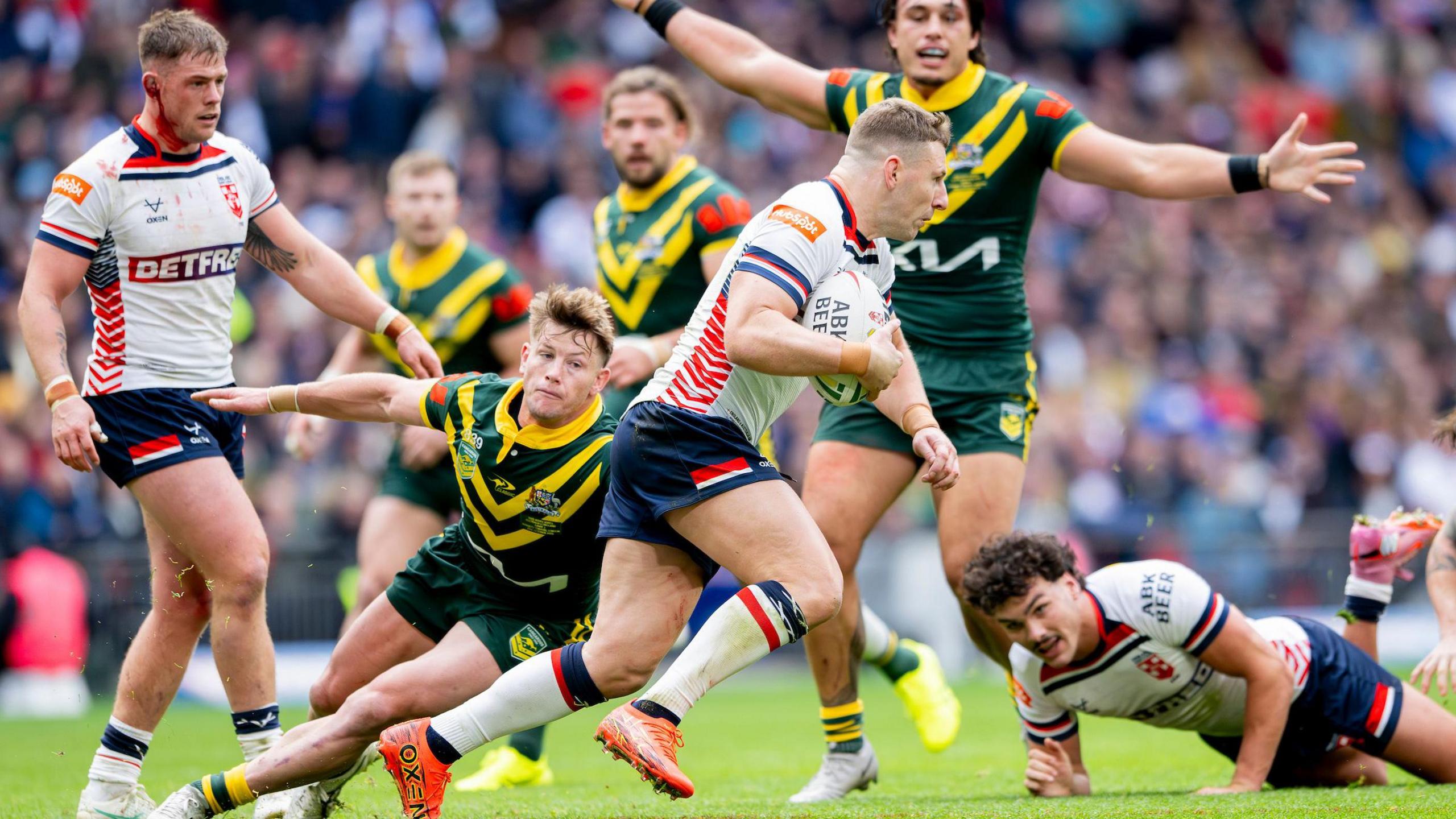 George Williams tries to pick his way through the Australia defence with the ball in hand, as Harry Grant reaches for a tackle and Tino Fa'asuamaleaui appeals to the referee with Herbie Farnworth on the floor