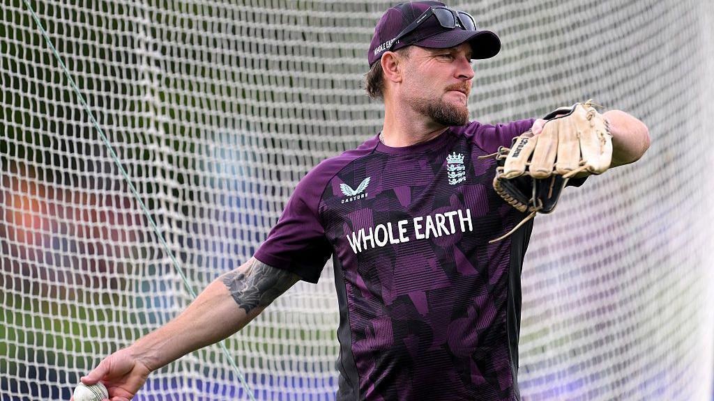 Coach Brendon McCullum of England throws a ball