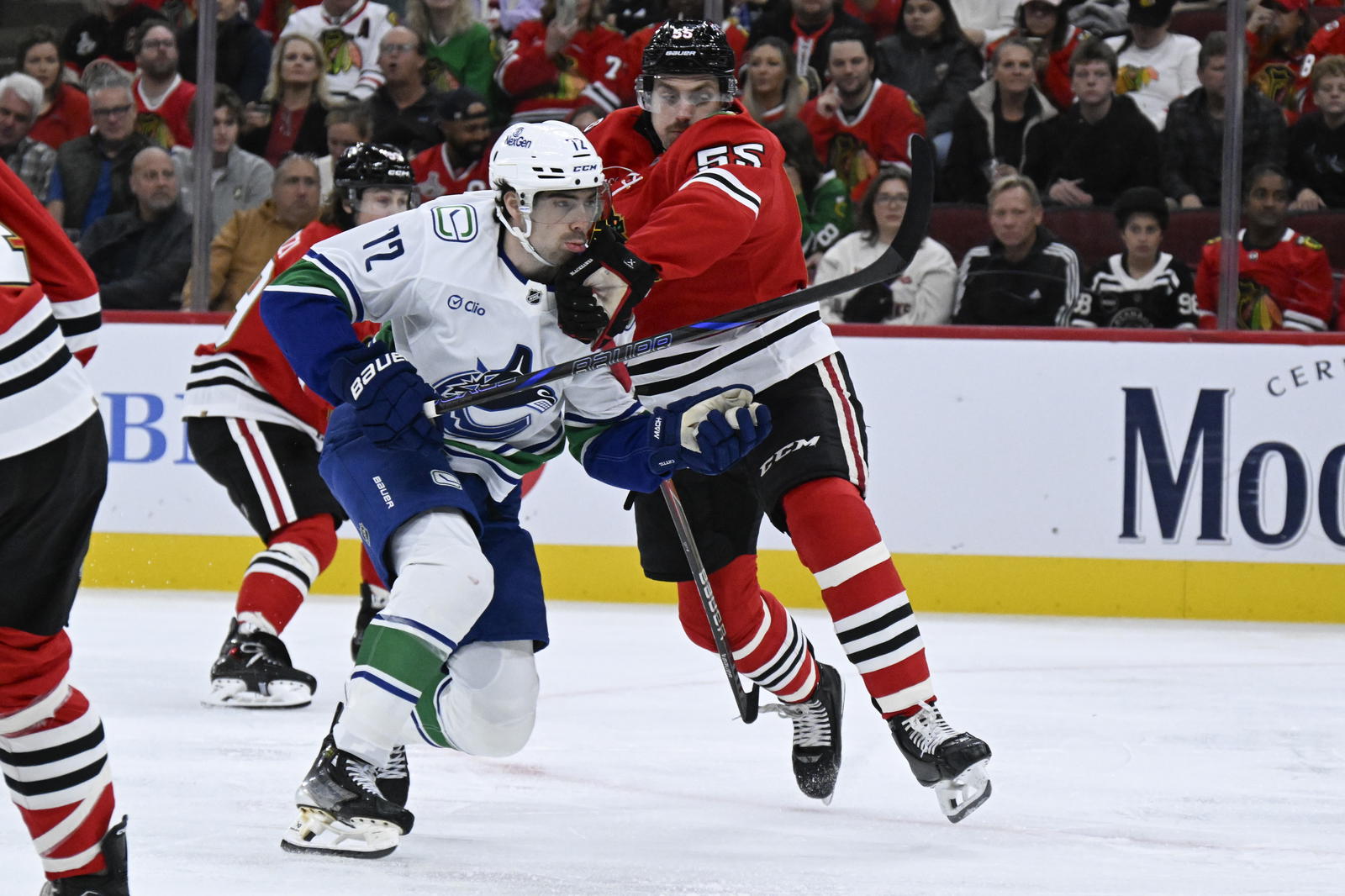 Oct 17, 2025; Chicago, Illinois, USA; Vancouver Canucks center Filip Chytil (72) and Chicago Blackhawks defenseman Artyom Levshunov (55) during the first period at the United Center. Mandatory Credit: Matt Marton-Imagn Images