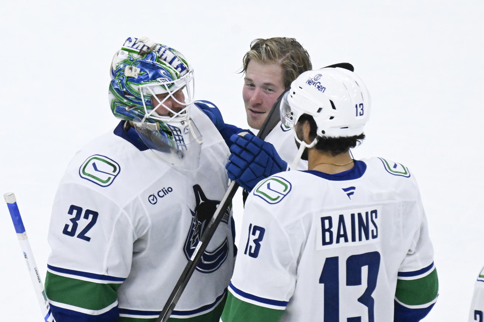 Oct 17, 2025; Chicago, Illinois, USA; Vancouver Canucks right wing Brock Boeser (6), center, celebrates with left wing Arshdeep Bains (13) and goaltender Kevin Lankinen (32) after the game against the Chicago Blackhawks at the United Center. Mandatory Credit: Matt Marton-Imagn Images
