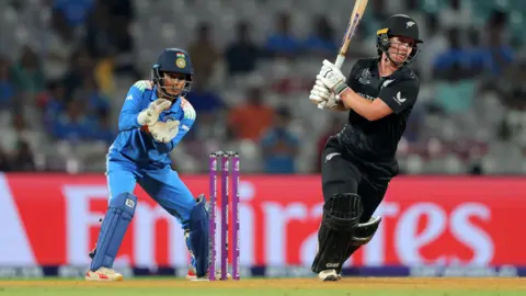 Getty Images Brooke Halliday of New Zealand bats as wicket keeper Richa Ghosh of India looks on during the ICC Women's Cricket World Cup India 2025 match between India and New Zealand at DY Patil Stadium on October 23, 2025 in Navi Mumbai, India.