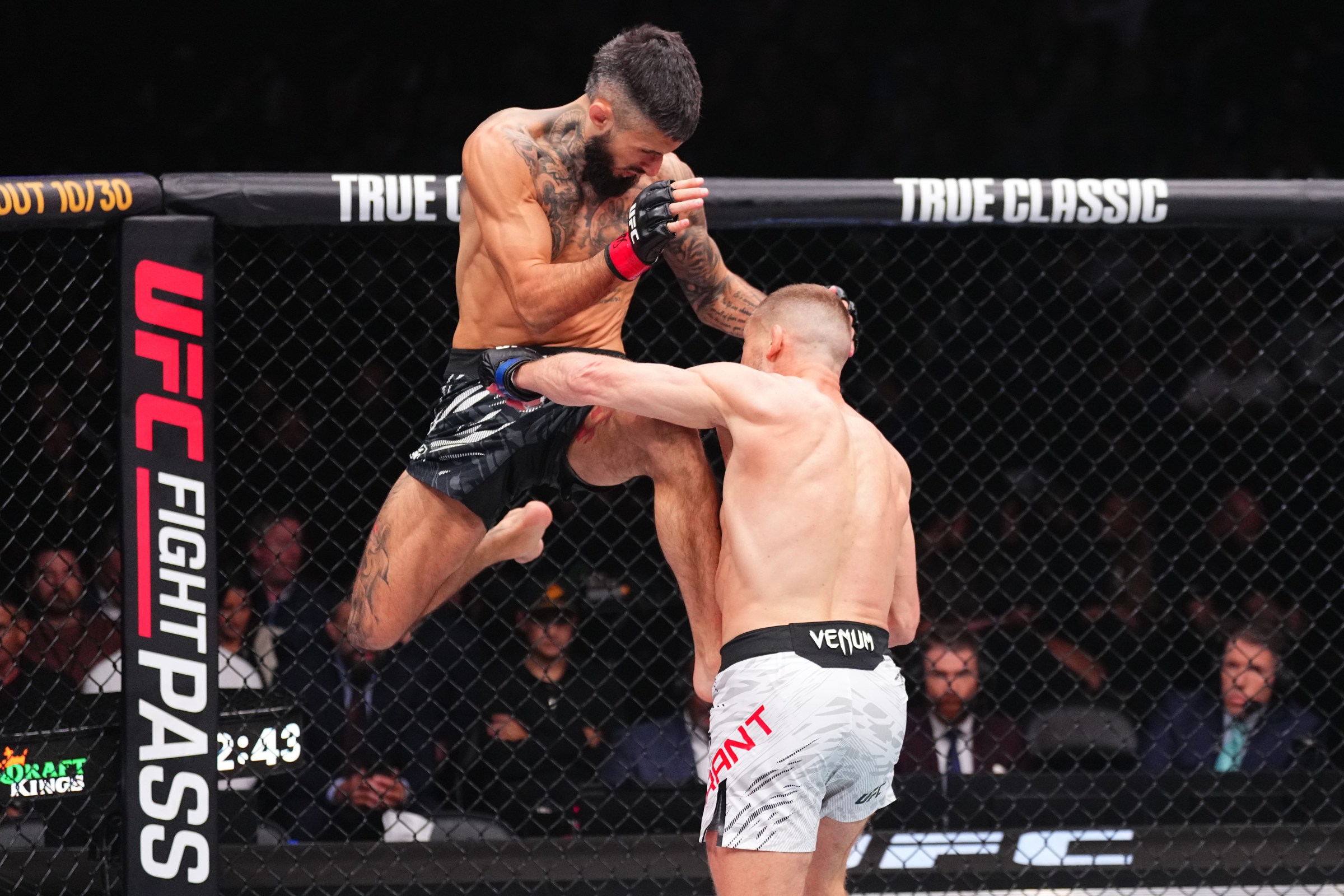 VANCOUVER, BRITISH COLUMBIA - OCTOBER 18: (L-R) Charles Jourdain of Canada throws a knee against Davey Grant of England in a bantamweight fight during the UFC Fight Night event at Rogers Arena on October 18, 2025 in Vancouver, British Columbia. (Photo by Jeff Bottari/Zuffa LLC)