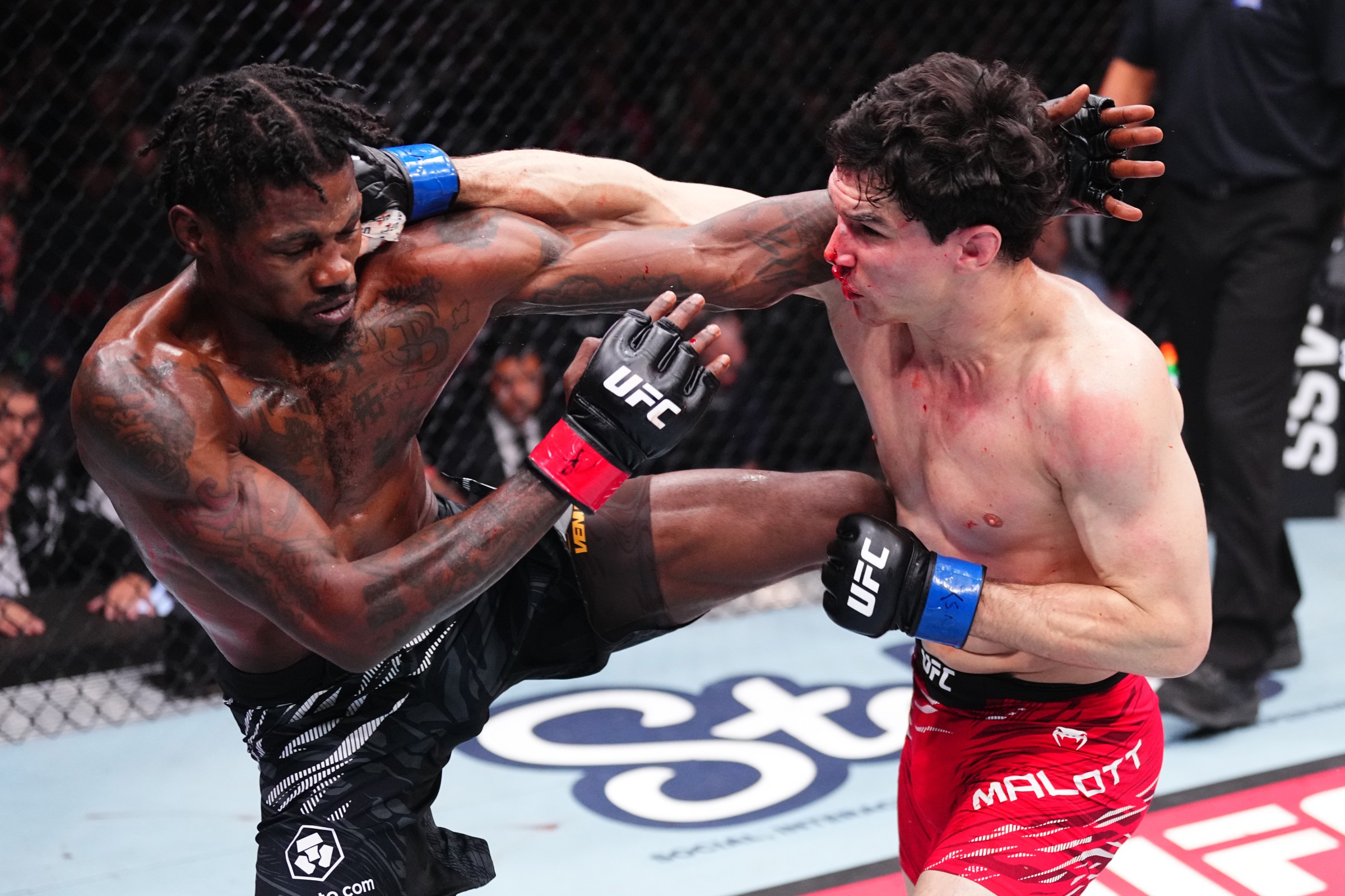 VANCOUVER, BRITISH COLUMBIA - OCTOBER 18: (R-L) Mike Malott punches Kevin Holland in a welterweight fight during the UFC Fight Night event at Rogers Arena on October 18, 2025 in Vancouver, British Columbia. (Photo by Jeff Bottari/Zuffa LLC)
