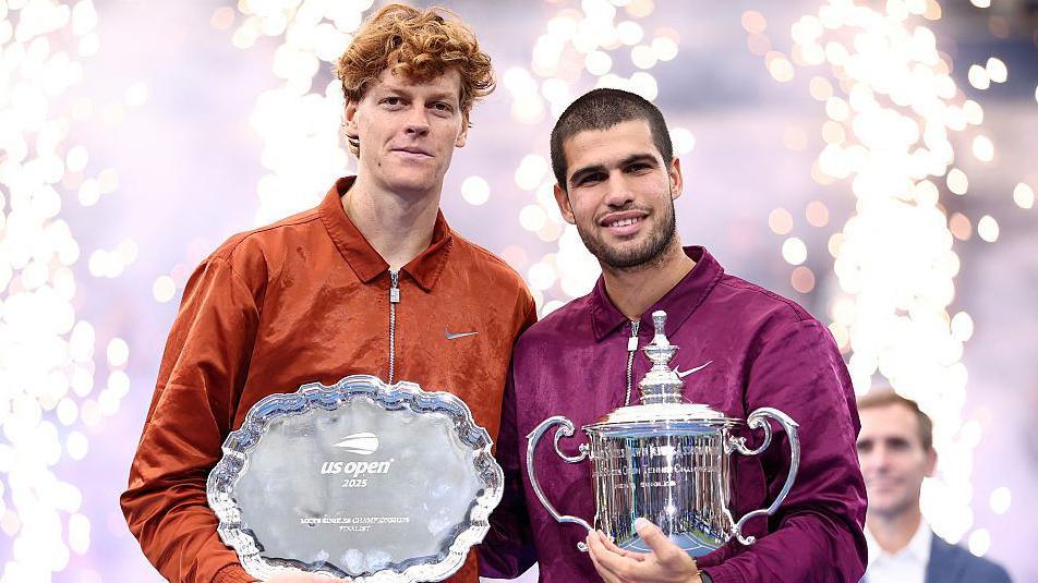 Jannik Sinner and Carlos Alcaraz show off their trophies after the US Open