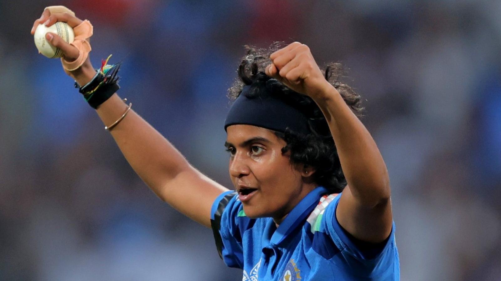 Sree Charani holds her arms aloft after taking a wicket