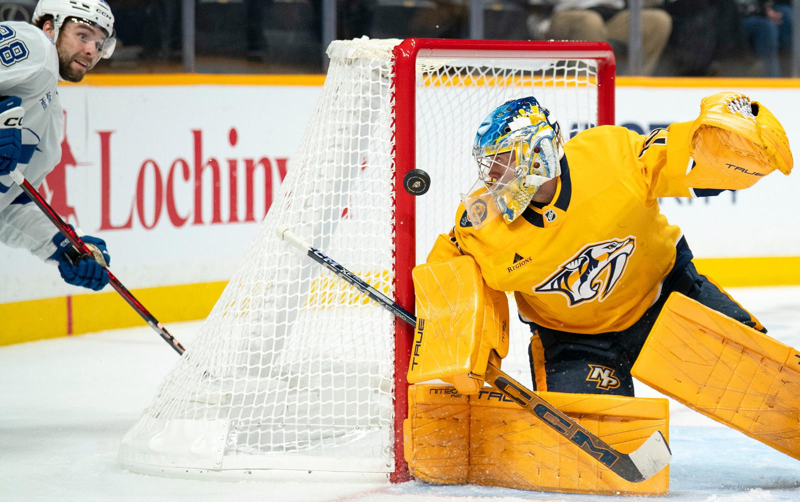 Tampa Bay left wing Brandon Hagel (38) gets off a shot against Nashville goaltender Juuse Saros (74) during their game at Bridgestone Arena in Nashville, Tenn., Tuesday, Oct. 28, 2025. Saros made the save.  Denny Simmons / The Tennessean / USA TODAY NETWORK via Imagn Images